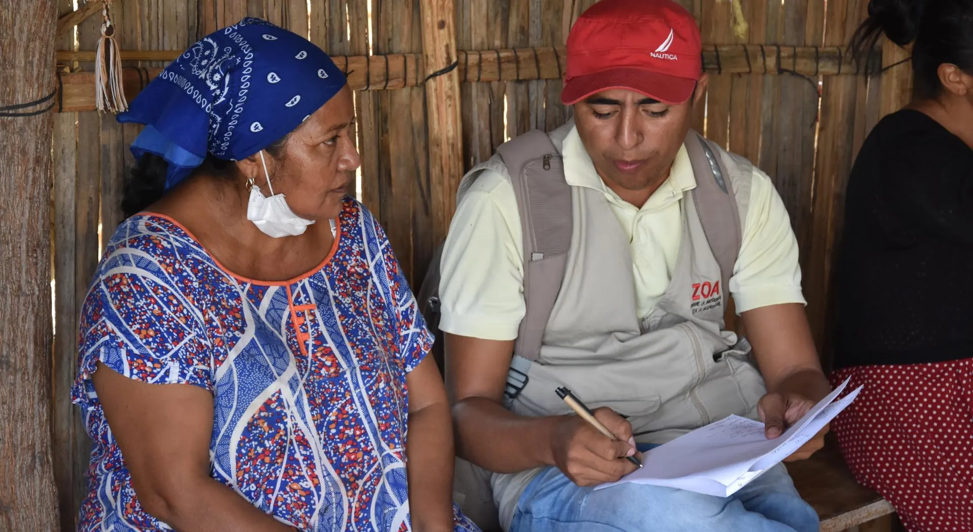A woman receives cash assistance