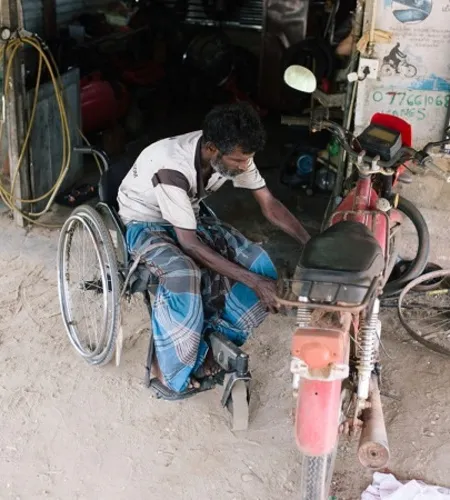 Mann im Rollstuhl erhält ein Mofa